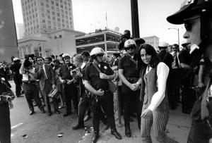 Folk singer Joan Baez is arrested by police and directed to a nearby police wagon during the sit-in demonstration in front of the Oakland Induction Center in Oakland, Calif., on Oct. 16, 1967.  Demonstrators blocked the building entrance in protest of the Vietnam war draft.  (AP Photo)