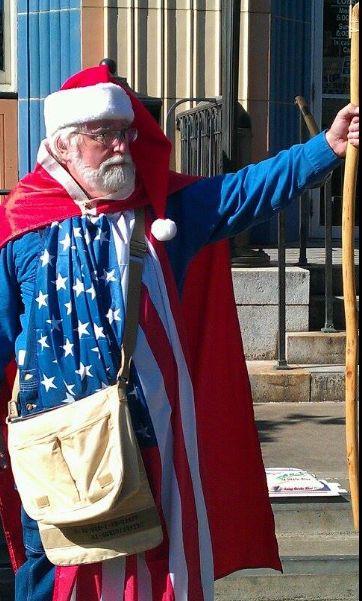 This image has an empty alt attribute; its file name is greg-santa5-1.png