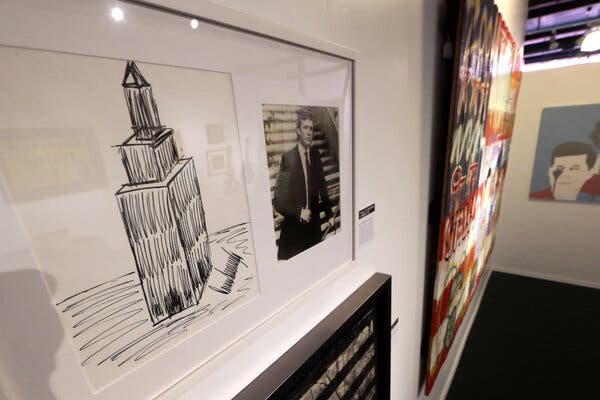 A drawing of the Empire State Building on display next to a photo of Donald Trump.
